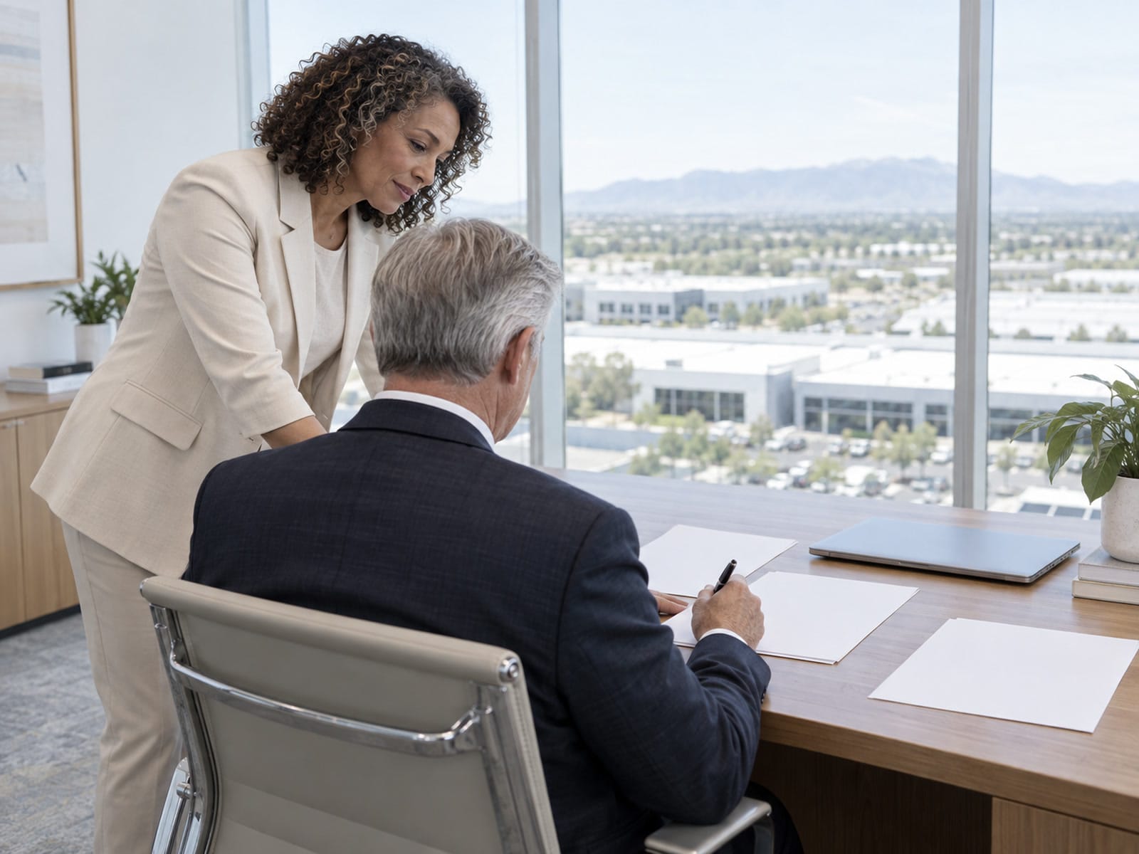 Two executives in a quiet corner conversation in an East Valley office