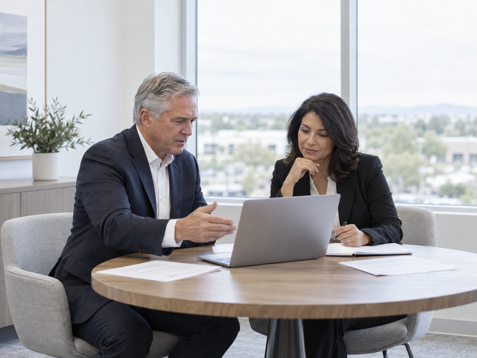 Two executives in a quiet corner conversation in a Gilbert office