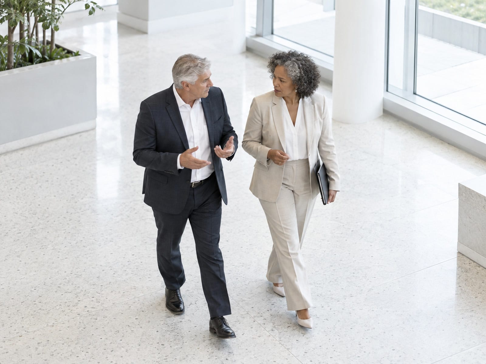 Two executives in a quiet corner conversation in an Arizona office