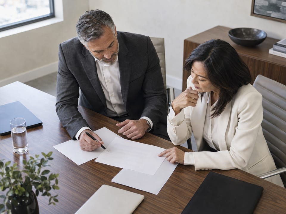 Executives in conversation in a Tucson office with southern Arizona light, no logos, no readable text