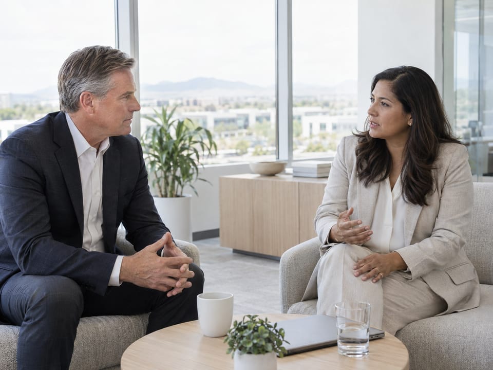 Two executives in a quiet corner conversation in a Chandler office