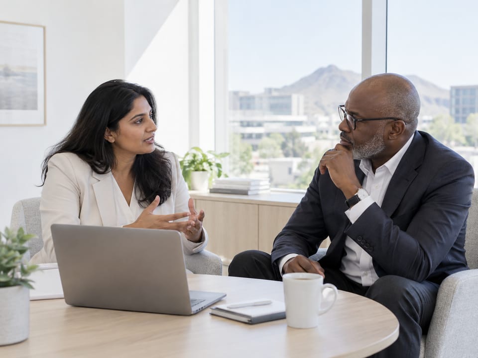 Two executives in a quiet corner conversation in a Tempe office